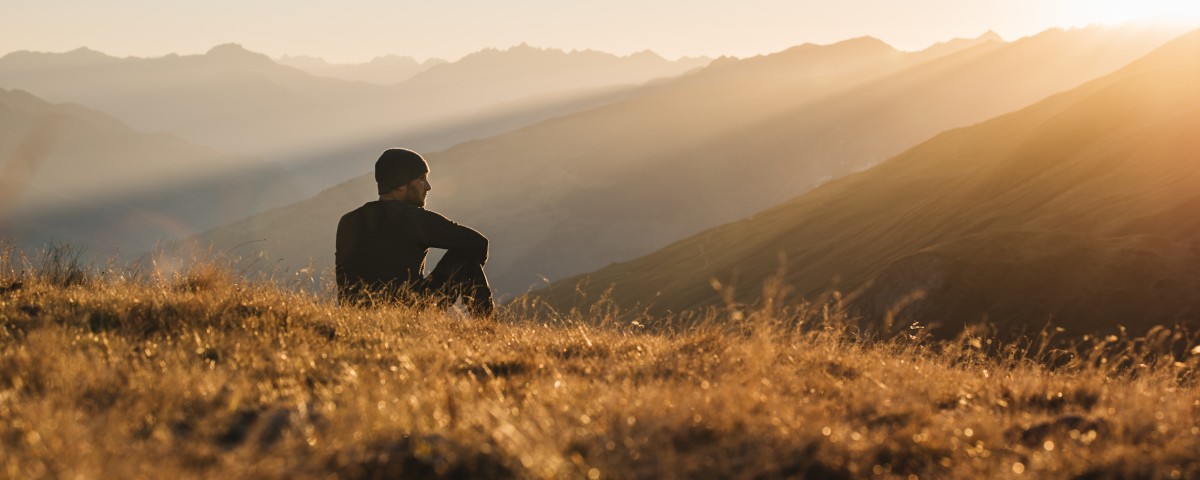 Man sitting on hill Man sitting on hill